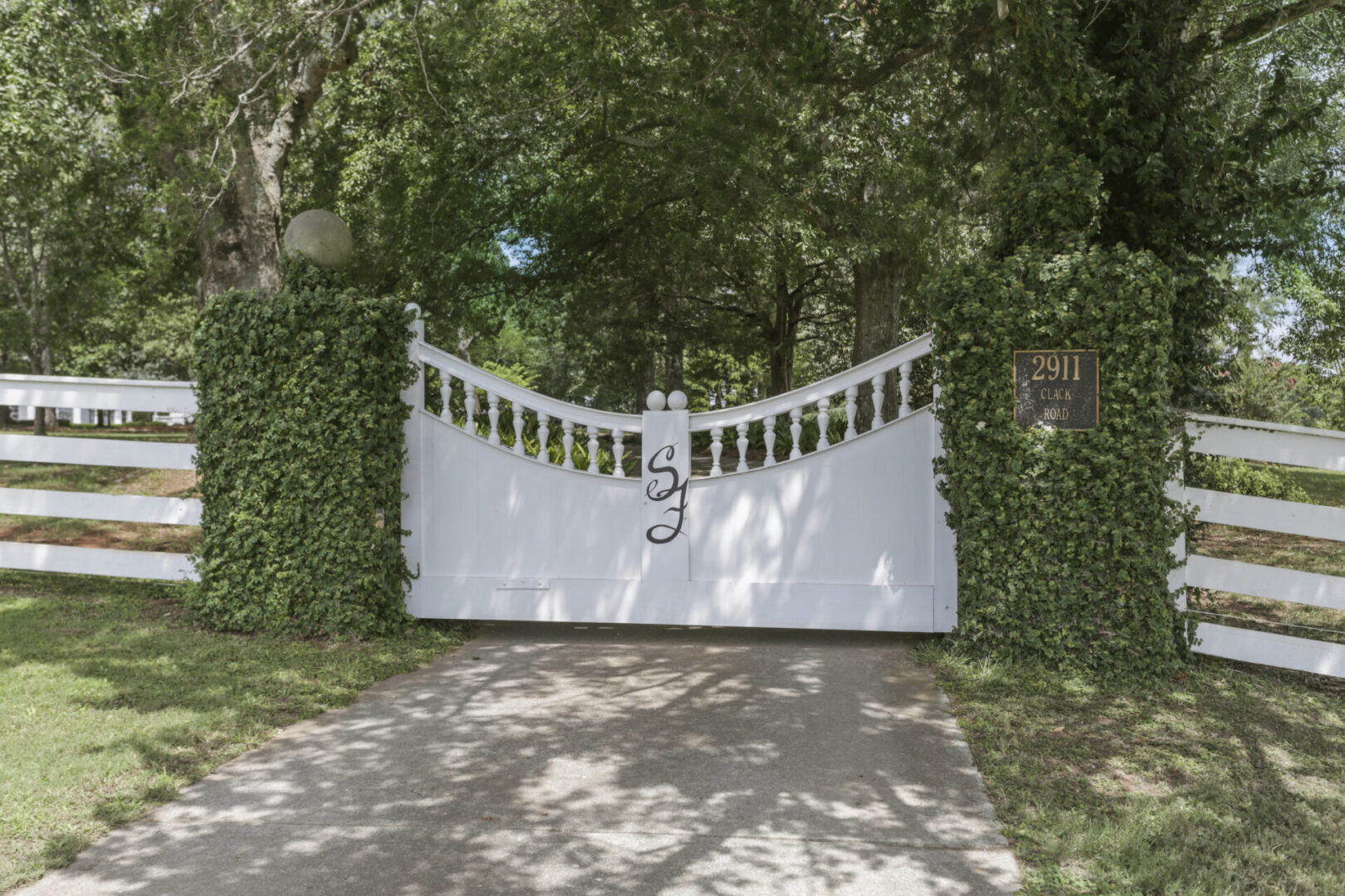 White gate and fence, entrance at Serenata Farm in Madison, GA